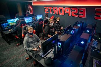 Students playing video games in the esports gaming studio.